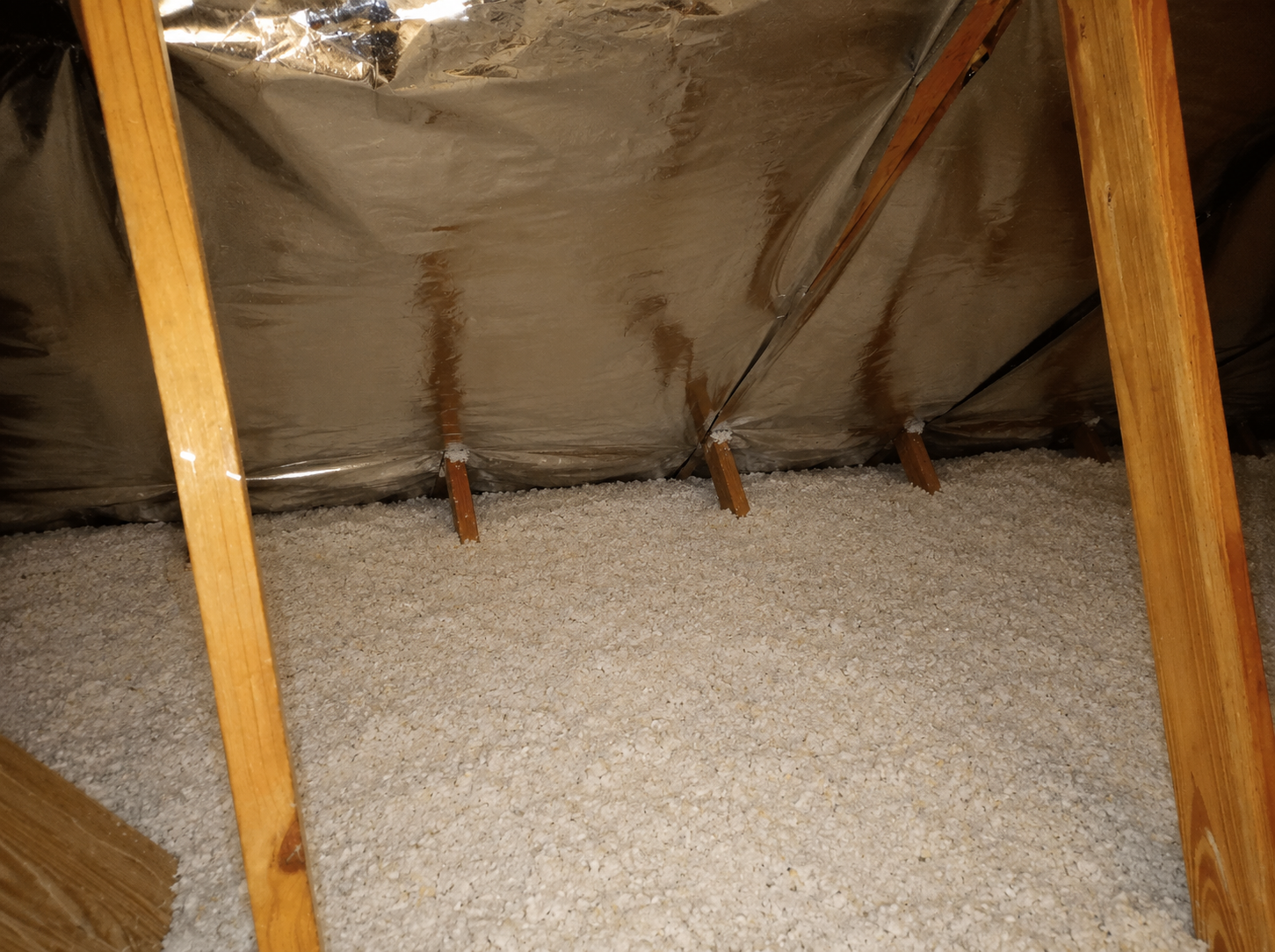 Blown-in fiberglass insulation reaching R-30 to R-38 depth in Florida attic