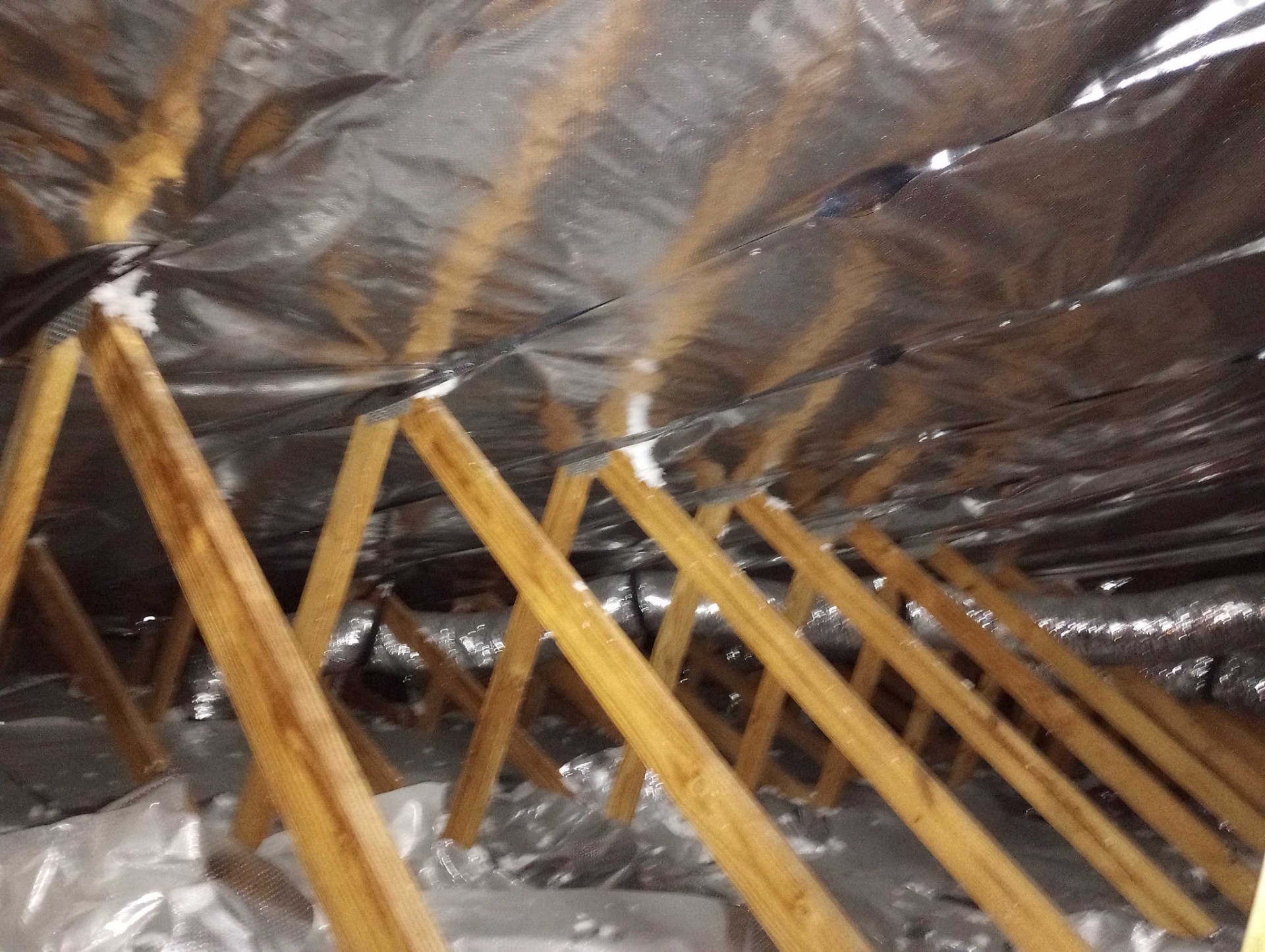 Attic radiant barrier Daytona Beach install stapled to rafters