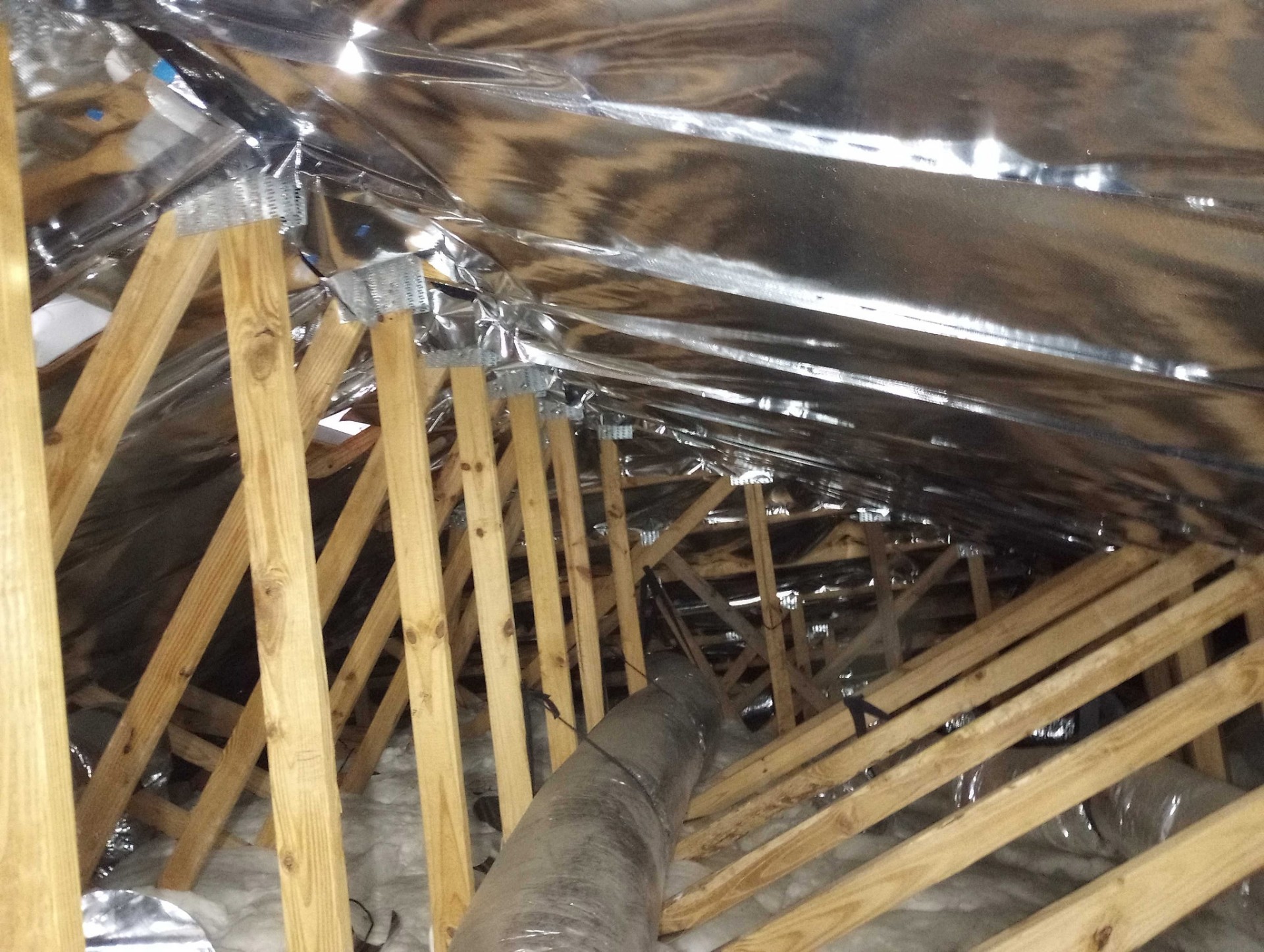 Radiant barrier foil installed on attic rafters in Daytona Beach Florida home